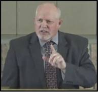 A person in a suit pointing his finger
AI-generated content may be incorrect.