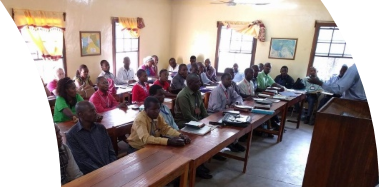 A group of people sitting at desks in a room

Description automatically generated with medium confidence